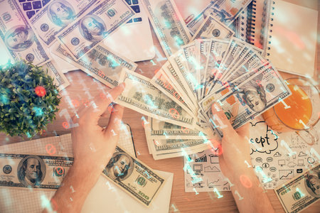 Multi exposure of technology drawing hologram and us dollars bills and man hands. Data conceptの写真素材