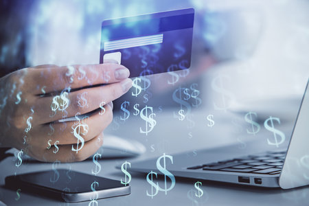 Multi exposure of woman on-line shopping holding a credit card and financial graph drawing. Stock market E-commerce concept.の写真素材