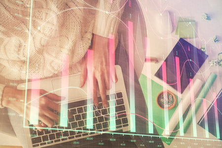 Multi exposure of woman hands working on computer and forex chart hologram drawing. Top View. Financial analysis concept.の写真素材
