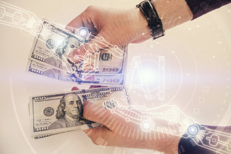 Multi exposure of technology drawing hologram and us dollars bills and man hands. Data concept