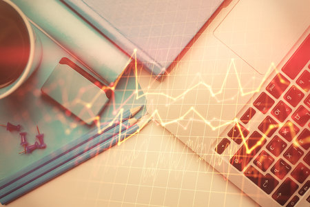 Double exposure of forex graph drawing over desktop background with computer. Concept of financial analysis. Top view.の写真素材