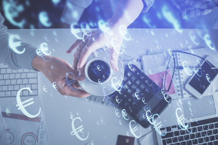 Double exposure of man and woman working together and financial chart hologram drawing. market analysis concept. Computer background. Top View.の写真素材