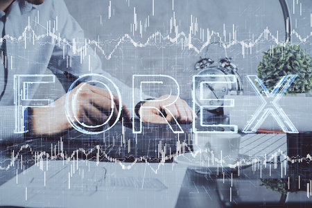 Double exposure of mans hands holding and using a phone and financial graph drawing. Analysis concept.の写真素材