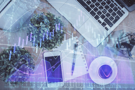 Multi exposure of financial chart hologram over desktop with phone. Top view. Mobile trade platform concept.の写真素材