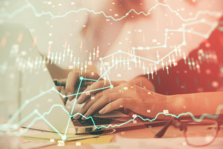 Multi exposure of woman hands typing on computer and financial graph hologram drawing. Stock market analysis concept.の写真素材