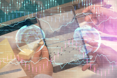 Double exposure of mans hands holding and using a phone and financial chart drawing. Market analysis concept.の写真素材