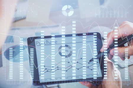 Double exposure of mans hands holding and using a phone and financial chart drawing. Market analysis concept.の写真素材