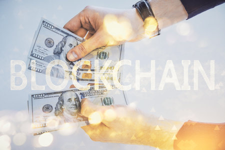 Multi exposure of blockchain theme drawing hologram and USA dollars bills and man hands. Business concept.の写真素材