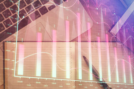 Stock market chart and top view computer on the table background. Double exposure. Concept of...