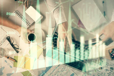 Double exposure of man and woman working together and forex graph hologram drawing. Financial...