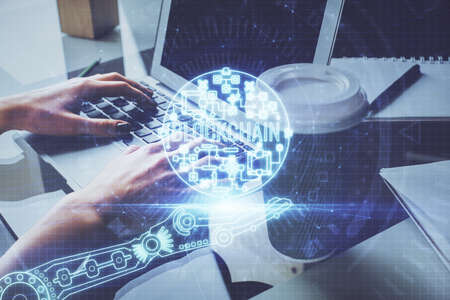 Double exposure of woman hands typing on computer and crypto market theme hologram drawing....