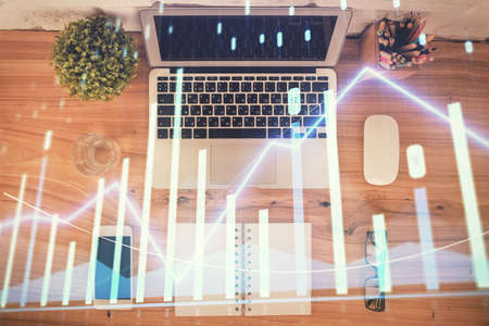 Multi exposure of financial chart drawing over table background with computer. Concept of research. Top view.の写真素材