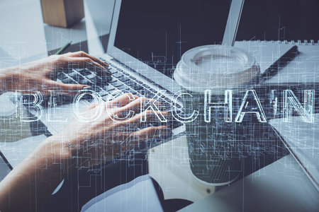 Double exposure of woman hands typing on computer and crypto market theme hologram drawing. Blockchain concept.の写真素材