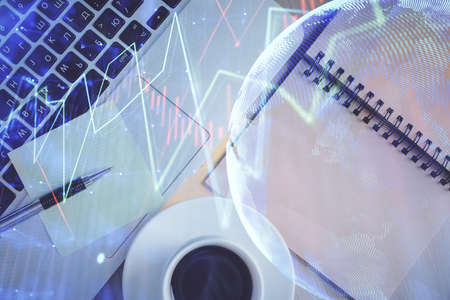 Stock market graph and top view computer on the table background. Double exposure. Concept of...