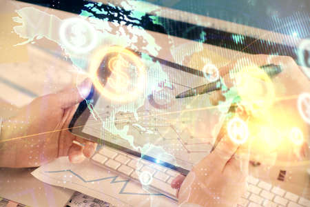 Double exposure of mans hands holding and using a phone and financial chart drawing. Market analysis...