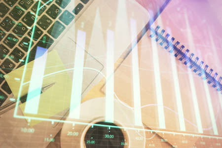 Stock market graph and top view computer on the table background. Double exposure. Concept of financial education.の写真素材