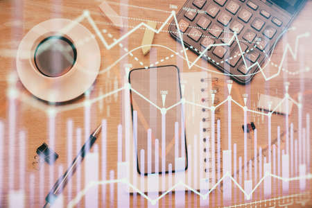 Multi exposure of forex graph hologram over desktop with phone. Top view. Mobile trade platform concept.の写真素材