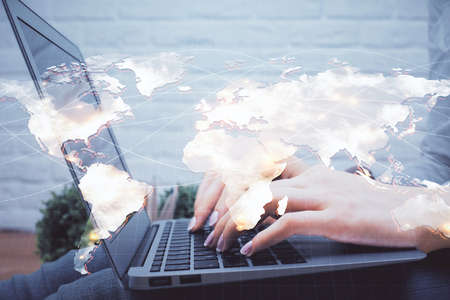 Double exposure of woman hands typing on computer and business theme hologram drawing. Success concept.の写真素材