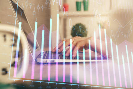 Double exposure of woman hands typing on computer and forex chart hologram drawing. Stock market...