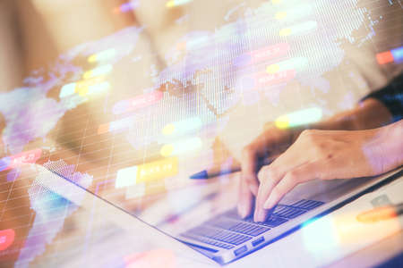 Double exposure of woman hands working on computer and data theme hologram drawing. Tech concept.