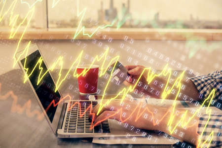 Double exposure of man hands holding a credit card and Forex graph drawing. Stock trading and...