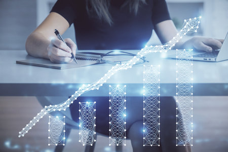 Double exposure of businesswoman hands typing on computer and forex chart hologram drawing. Financial analysis concept.の写真素材