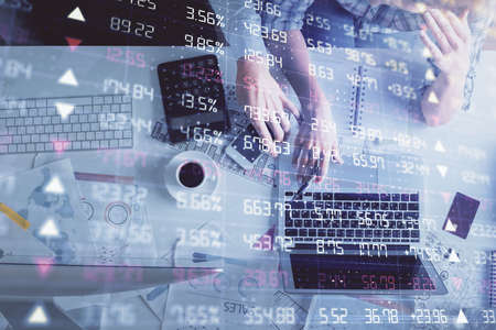 Double exposure of man and woman working together and financial graph hologram drawing. market...