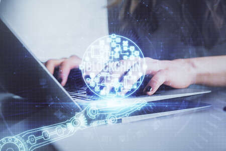 Double exposure of woman hands typing on computer and crypto market theme hologram drawing....