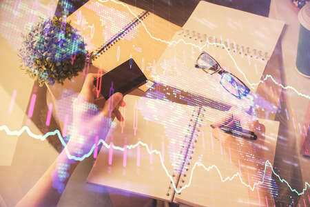 Multi exposure of woman on-line shopping holding a credit card and financial graph drawing. Stock...