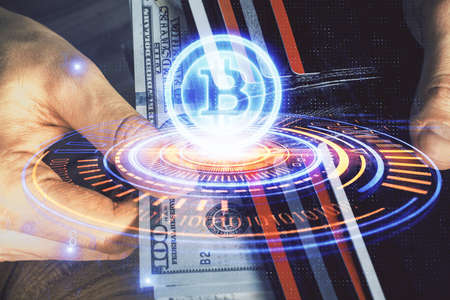Multi exposure of blockchain theme drawing hologram and USA dollars bills and man hands. Business...