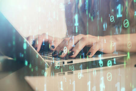 Double exposure of woman hands working on computer and data theme hologram drawing. Tech concept.