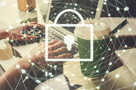 Double exposure of woman hands working on computer and lock hologram drawing. Security concept.