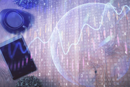 Multi exposure of financial chart hologram over desktop with phone. Top view. Mobile trade platform...