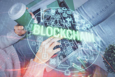 Double exposure of woman hands typing on computer and crypto market theme hologram drawing....