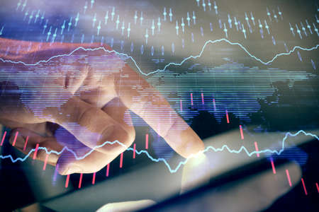 Multi exposure of mans hands holding and using a phone and financial chart drawing. Market analysis...