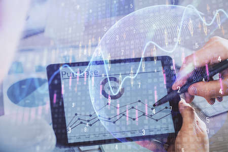 Double exposure of mans hands holding and using a phone and financial chart drawing. Market analysis...