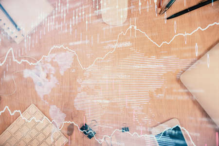 Multi exposure of forex graph hologram over desktop with phone. Top view. Mobile trade platform concept.の写真素材