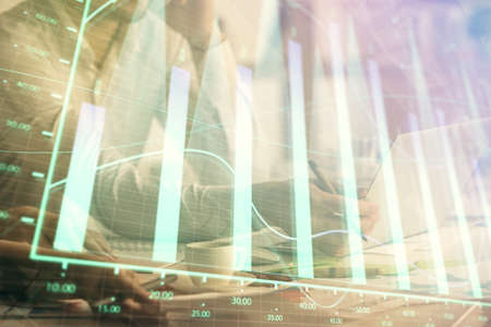 Multi exposure of man and woman working together and financial chart hologram. Business concept. Computer background.の写真素材