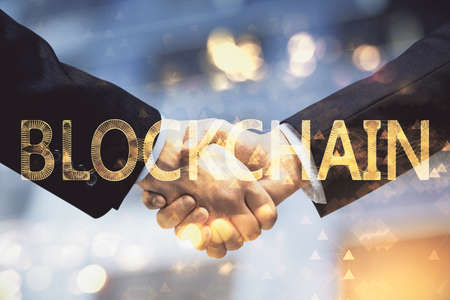 Double exposure of blockchain hologram and handshake of two men. Crypto business concept.