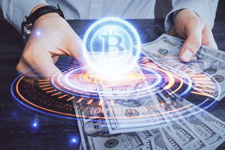 Multi exposure of blockchain theme drawing hologram and USA dollars bills and man hands. Business...