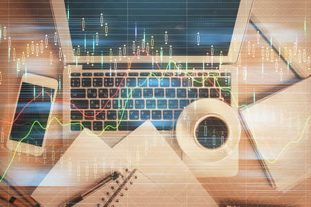 Stock market chart and top view computer on the table background. Double exposure. Concept of...
