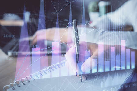 Double exposure of forex chart drawing over people taking notes background. Concept of financial...