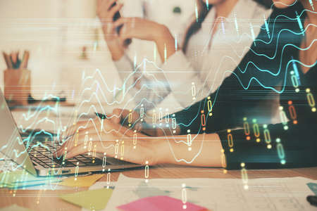 Multi exposure of woman hands typing on computer and financial graph hologram drawing. Stock market...