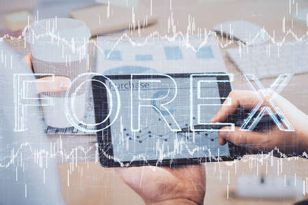 Double exposure of mans hands holding and using a phone and financial chart drawing. Market analysis concept.の写真素材