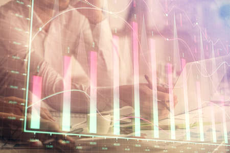 Multi exposure of man and woman working together and financial chart hologram. Business concept....