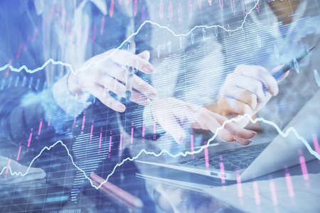 Multi exposure of man and woman working together and financial chart hologram. Business concept....