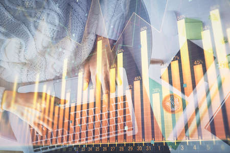 Multi exposure of woman hands working on computer and forex chart hologram drawing. Top View. Financial analysis concept.の写真素材
