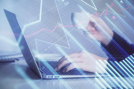 Double exposure of businesswoman hands typing on computer and forex graph hologram drawing....