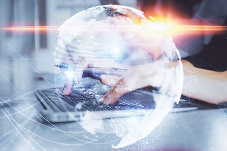 Multi exposure of woman hands typing on computer and business theme hologram drawing. Success concept.の写真素材