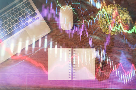 Stock market graph and top view computer on the table background. Double exposure. Concept of...